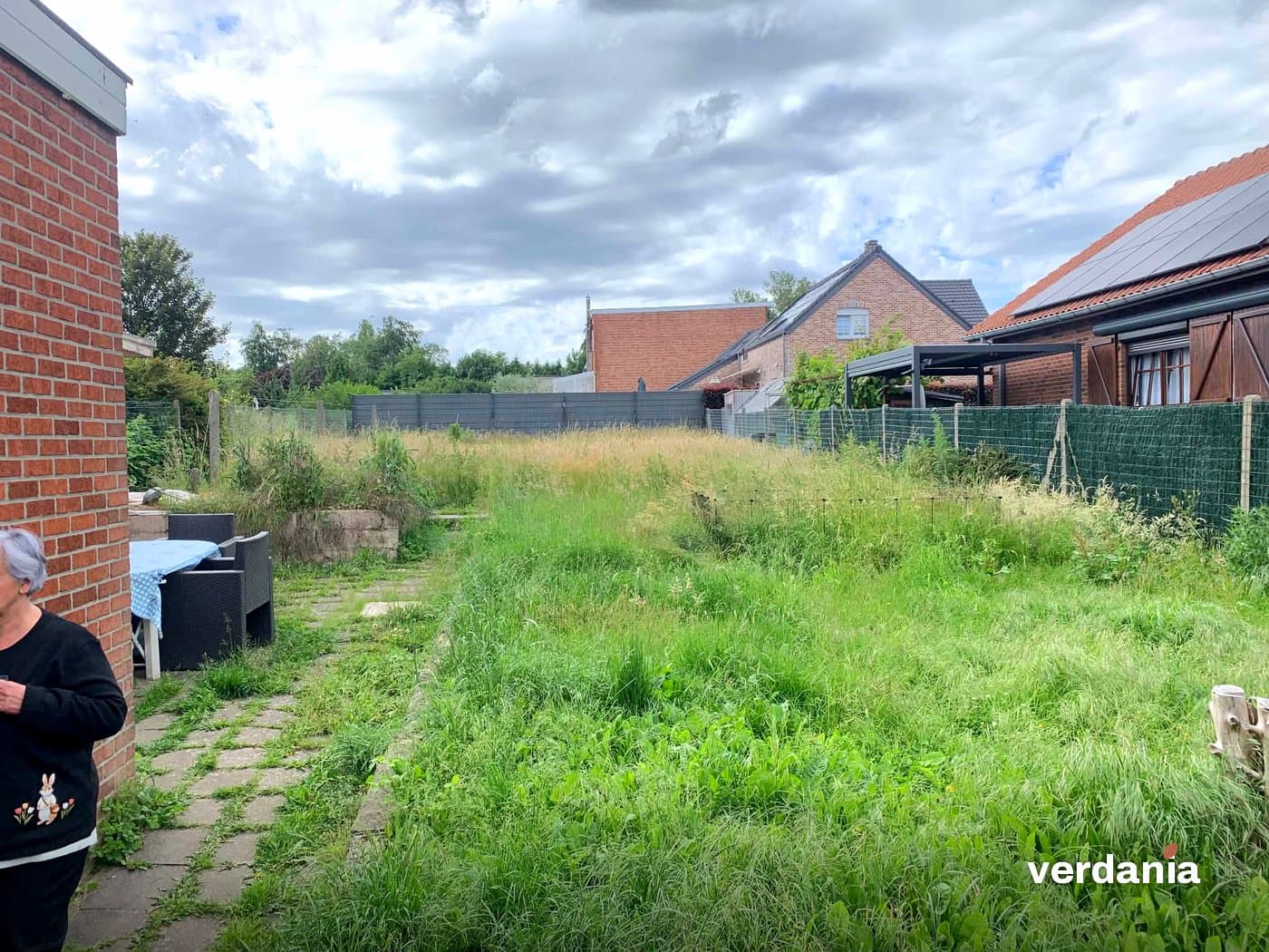 Terrasse envahie et pelouse haute avant nettoyage — Région liégeoise